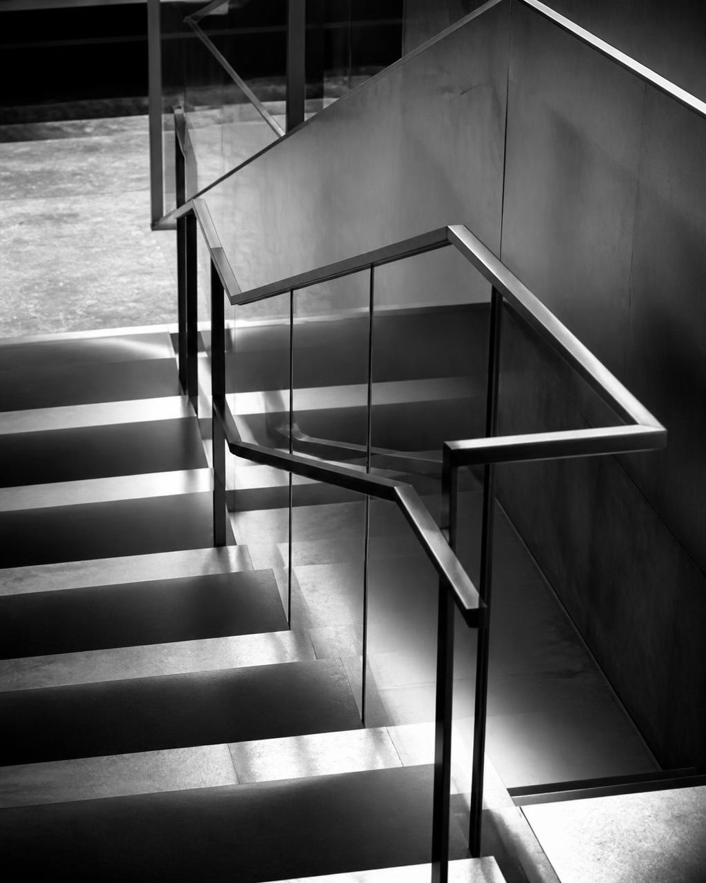 Modern stairwell with repeating geometric lines in black and white